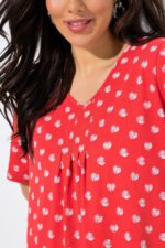 oranzine tunika su baltais taskais ir klostemis